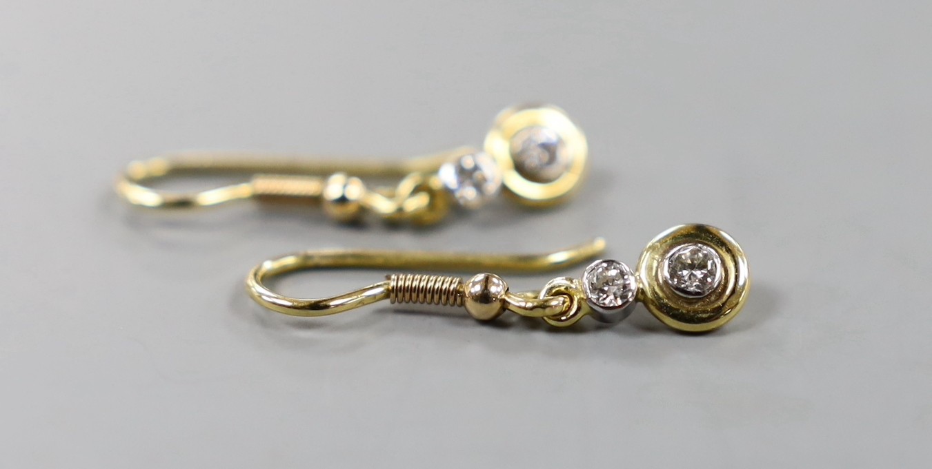 A pair of yellow metal and two stone diamond set drop earrings, overall 25mm, gross weight 2.1 grams.
